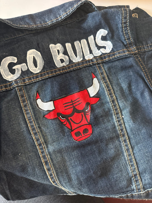 Denim jacket with 'G-O BULLS' text and a red bull logo on a plain background